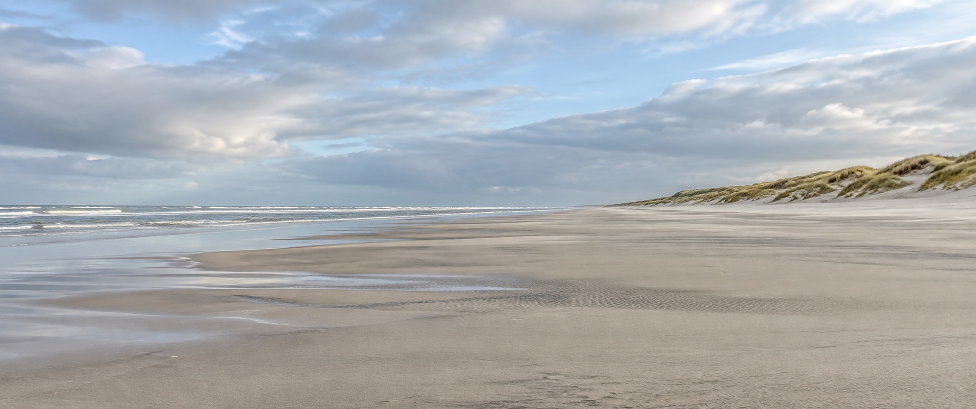 Wide empty sandy beach and dunes on Terschelling's North Sea side